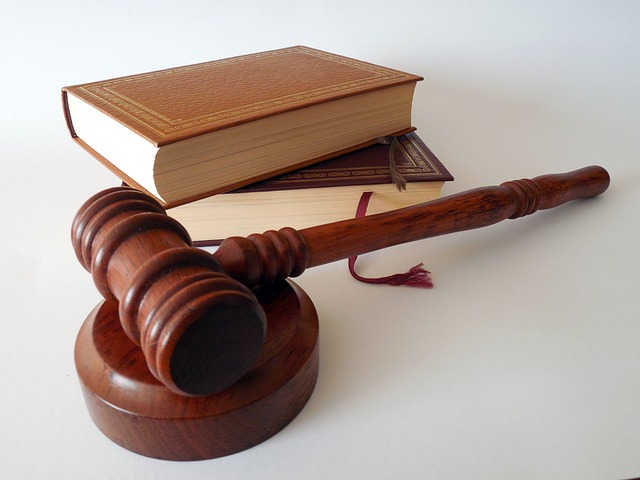 A wooden gavel and sounding block resting next to stacked law books, representing DWI Lawyer Gaylord MI services.