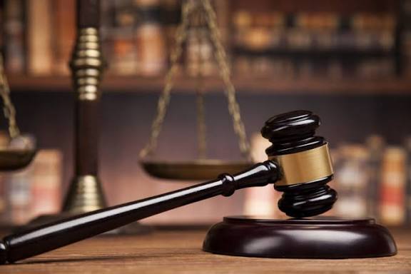 Wooden gavel and scales of justice on a desk, representing legal defense by a DUI Arrest Defense Lawyer.