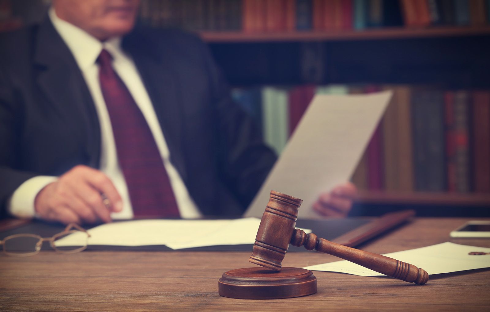An attorney reviewing legal documents at a desk with a gavel, representing a First Offense OWI Lawyer.